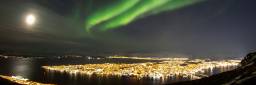 Bright northern lights above Tromsø city, Norway